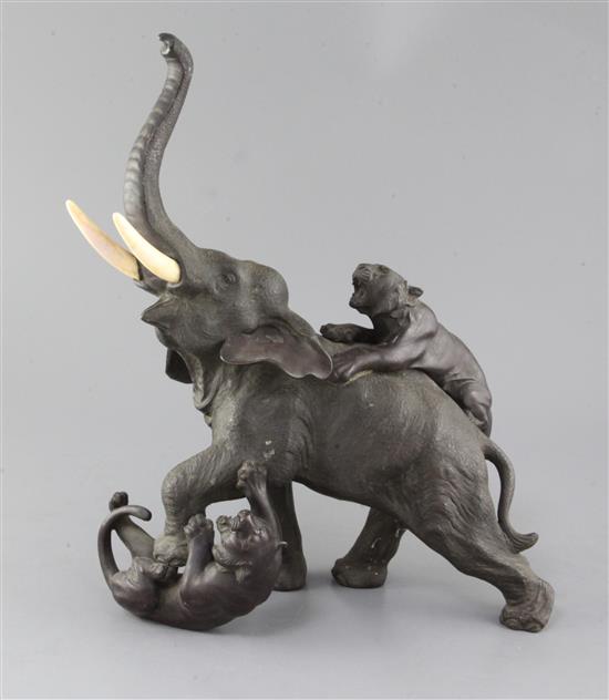 A large Japanese bronze group of tigers attacking an elephant, Meiji period, height 39cm length 31cm